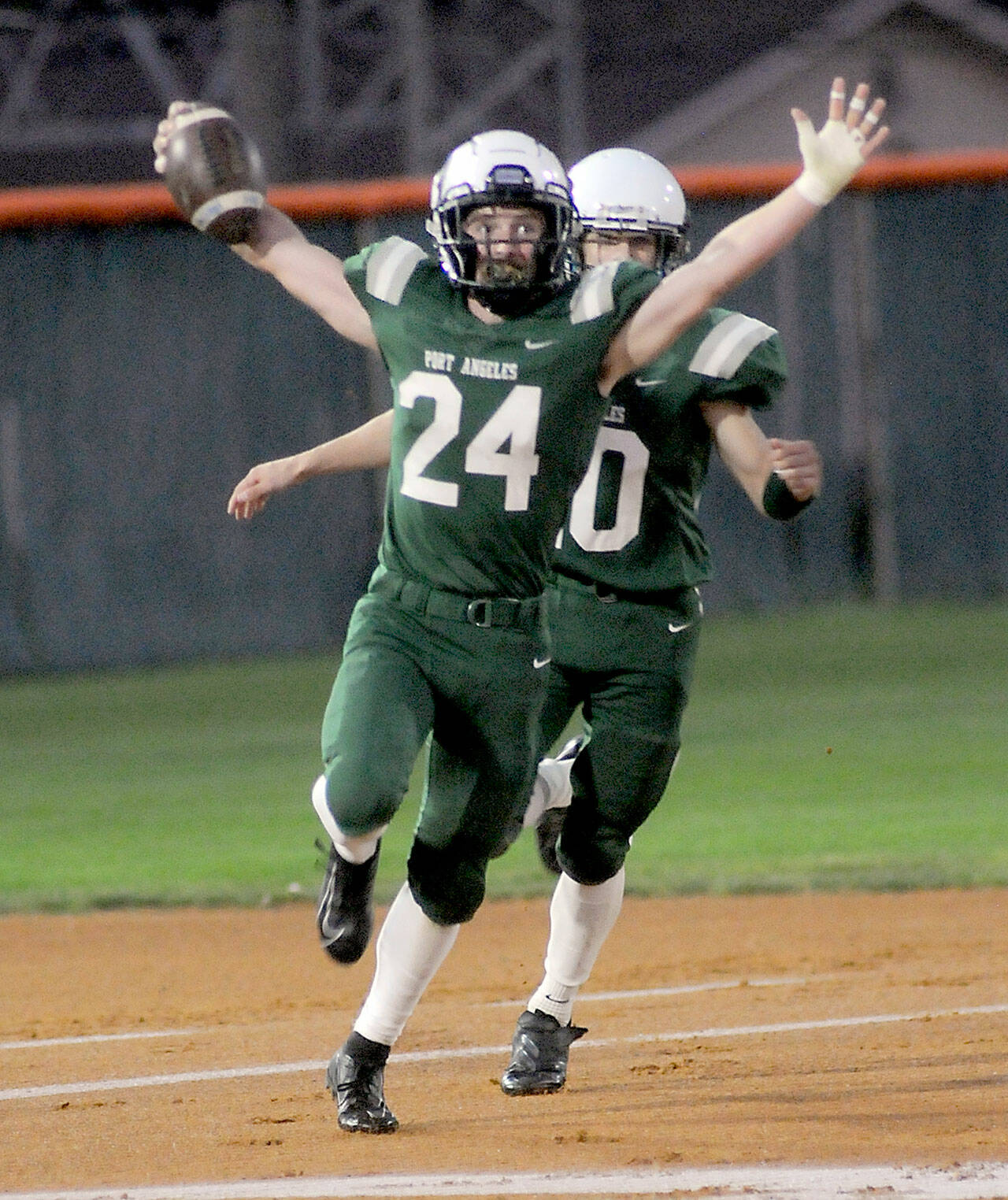 Port Angeles’ James Browning, accompanied by teammate Xavier Nelson, celebrates a touchdown run after intercepting a pass from Bremerton’s Aiga Logova in the first quarter on Friday night at Port Angeles Civic Field. (KEITH THORPE/PENINSULA DAILY NEWS)