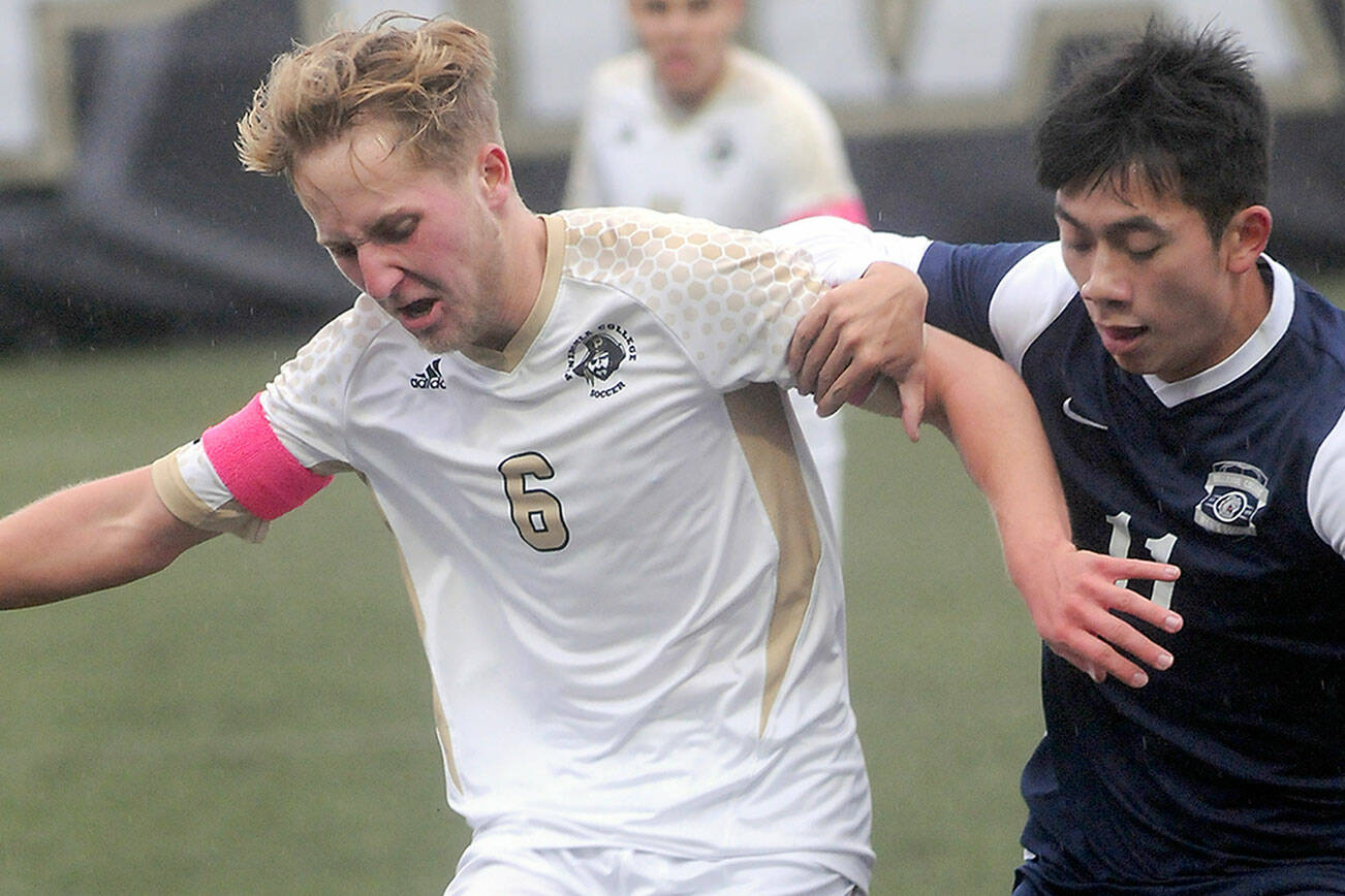 KEITH THORPE/PENINSULA DAILY NEWS
Peninsula's Tim Dreser pushes back against Bellevue's Thomas Nguyen on Wednesday in Port Angeles.