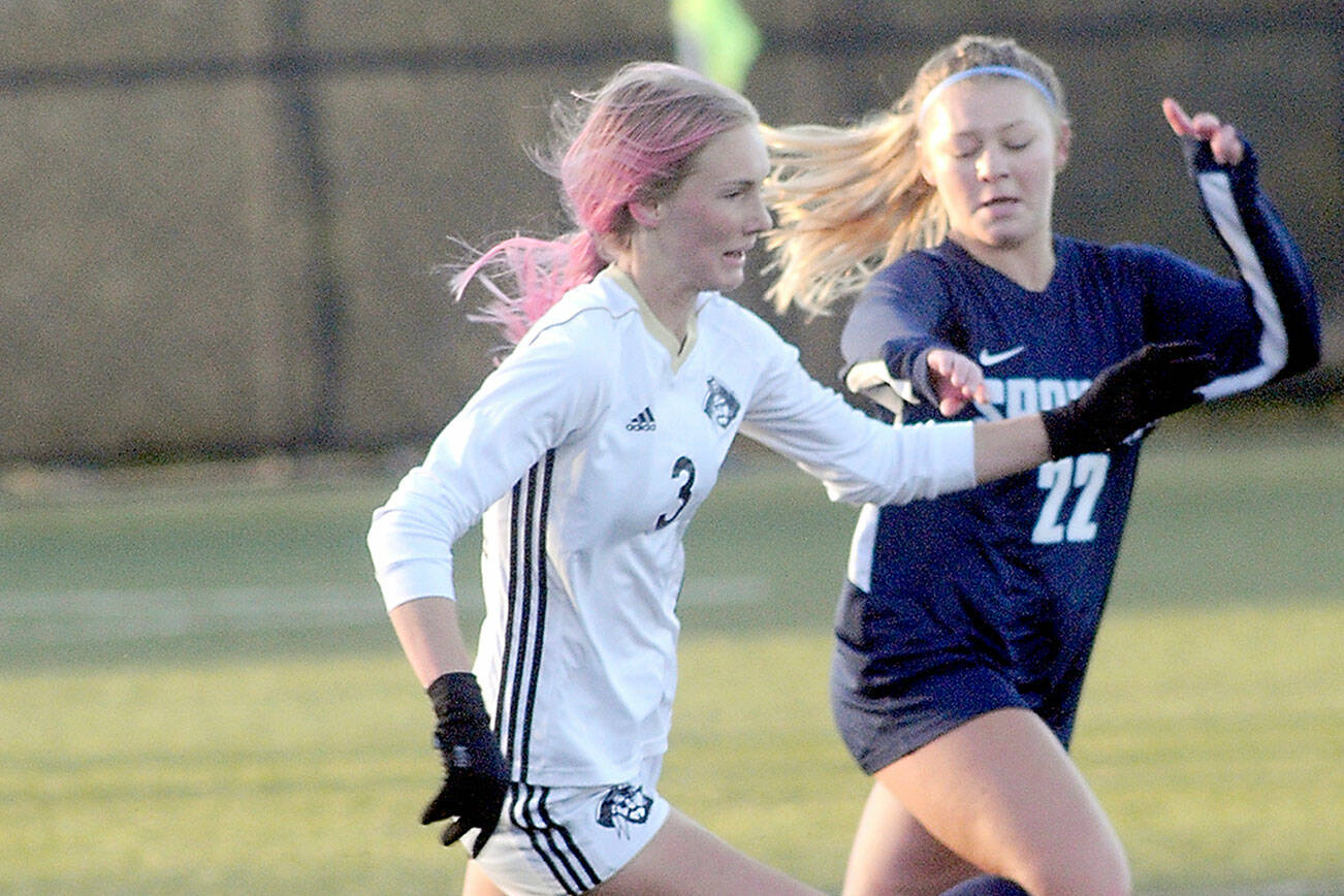 KEITH THORPE/PENINSULA DAILY NEWS
Peninsula's Millie Long, left, races downfield with Spokane's Aubrey Thomas in pursuit during Saturday's NWAC quarterfinal game at Wally Sigmar Field in Port Angeles.