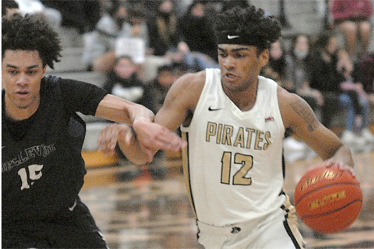 Peninsula’s Roosevelt Williams Jr., right, tries to push past Bellevue’s Nate Johnson on Saturday evening on the Pirate home court. (Keith Thorpe/Peninsula Daily News)