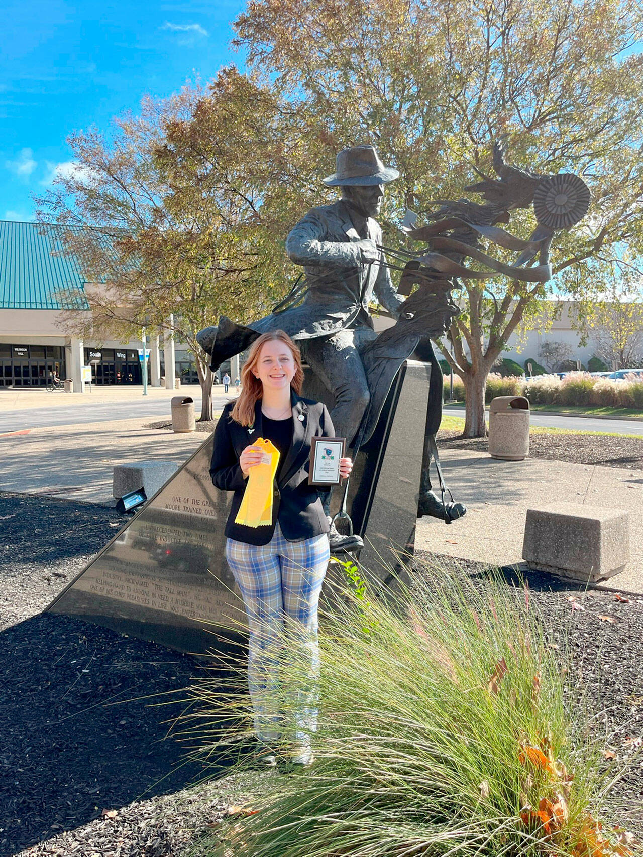 Neon Riders 4-H Club’s Ruby Coulson stands in front of the renowned Saddlebred Horseman Tom Moore’s statue fresh from her win in the Individual Presentation Contest for her slide-show and speech, “Equine Regenerative Therapies.” at the 4-H National competition in Kentucky. Billed as the Largest Youth Equine Education Event in North America, it’s a huge accomplishment for the young woman from Sequim. (Submitted photo)