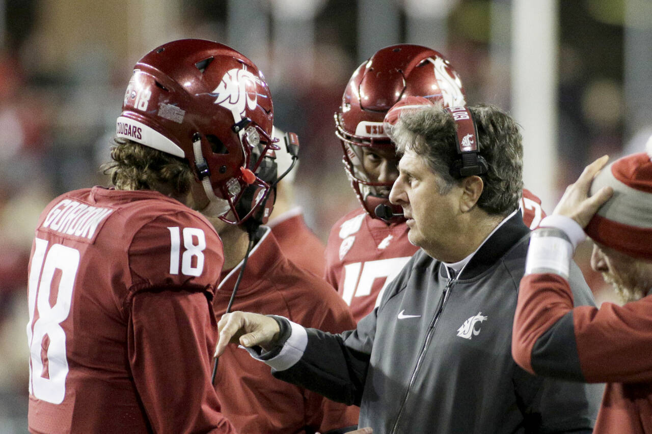 Washington State head coach Mike Leach, right, speaks with quarterback Anthony Gordon (18) during the second half of a game against Stanford in Pullman on Nov. 16, 2019. (Young Kwak/The Associated Press)