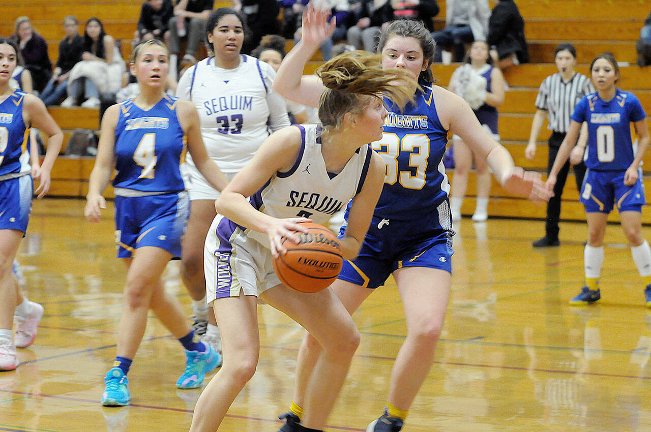 Sequim junior Jolene Vaara keeps her eyes on the basket while defended by Bremerton. Vaara is an Olympic League MVP candidate this season. (Matthew Nash/Olympic Peninsula News Group)