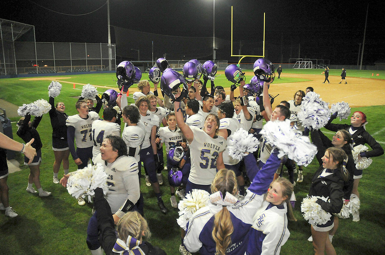 Members of the Sequim Wolves football team and cheer squad celebrate Friday night’s 36-32 come-from-behind victory over the Port Angeles Roughriders at Port Angeles Civic Field. (Keith Thorpe/Peninsula Daily News)