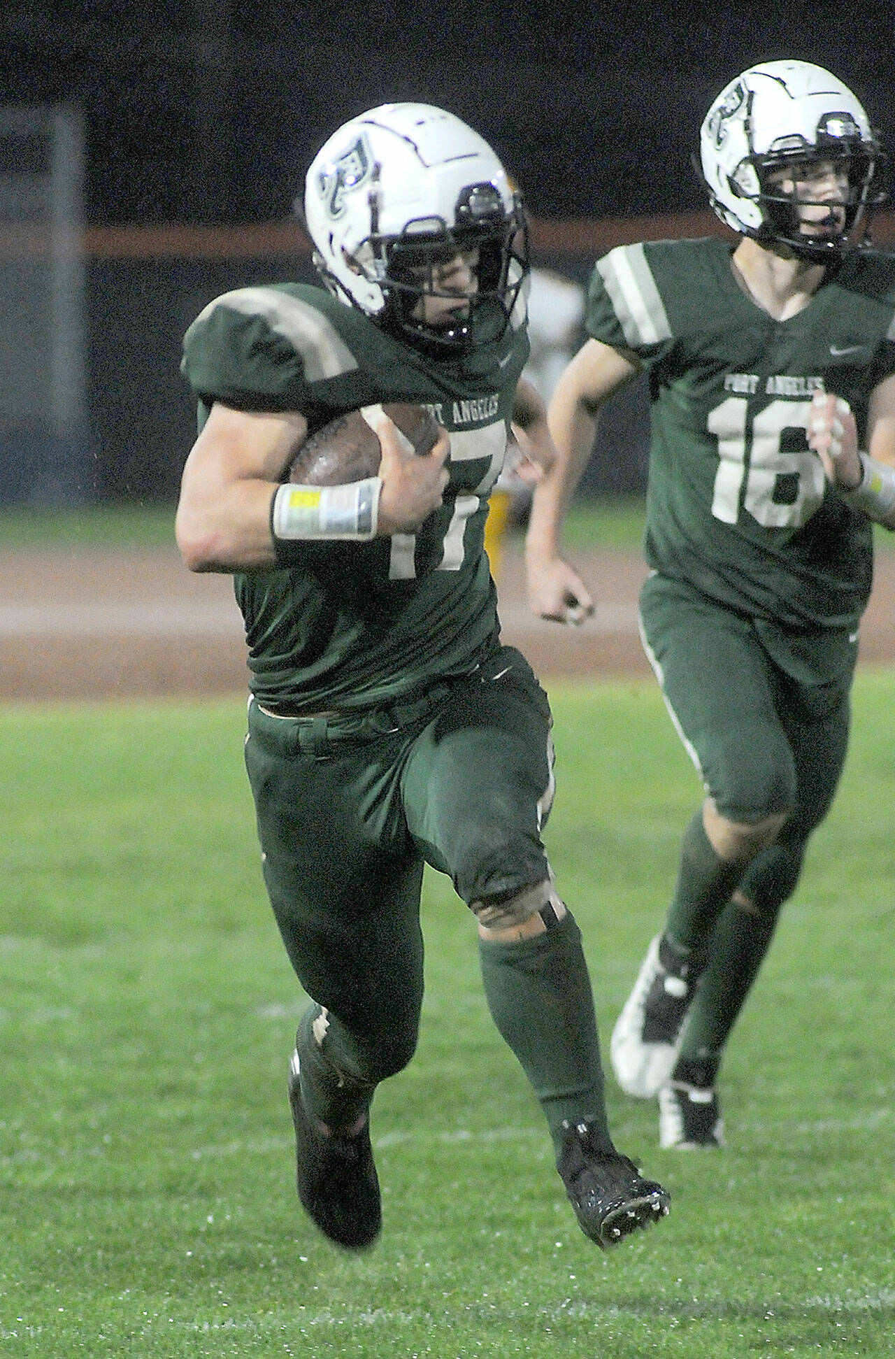 Port Angeles’ Jason Hawes, left, takes a punt return from deep in Roughrider territory for a second quarter touchdown against Kingston as teammate Blake Sohlberg follows behind on Friday at Port Angeles Civic Field. (Keith Thorpe/Peninsula Daily News)