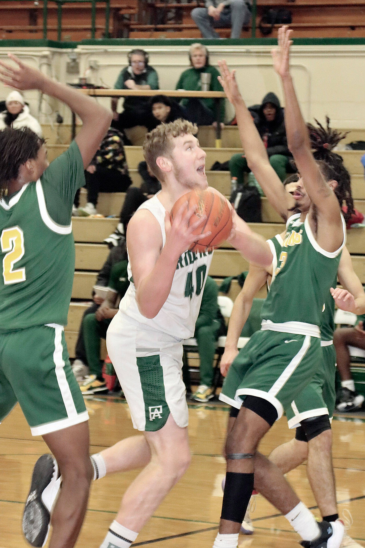 Port Angeles’ Isaiah Shamp drives hard to the basket between the hands of Foss defenders last week. (Dave Logan/for Peninsula Daily News)