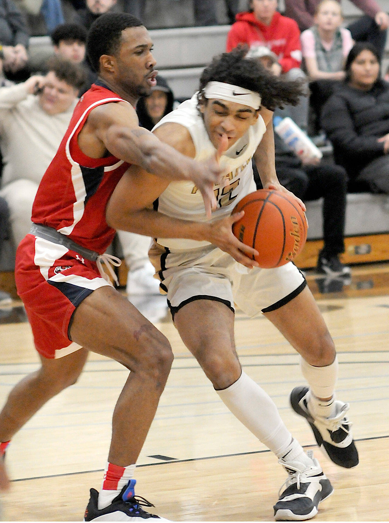 Peninsula’s Roosevelt Williams Jr., right, shoulders his way past Skagit Valley’s Omari Maulana during Wednesday’s North Division game at Peninsula College. (Keith Thorpe/Peninsula Daily News)