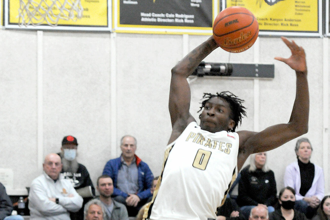 Keith Thorpe/Peninsula Daily News
Peninsula's Ese Onakpoma goes up for the jam against Bellevue on Wednesday night in Port Angeles.