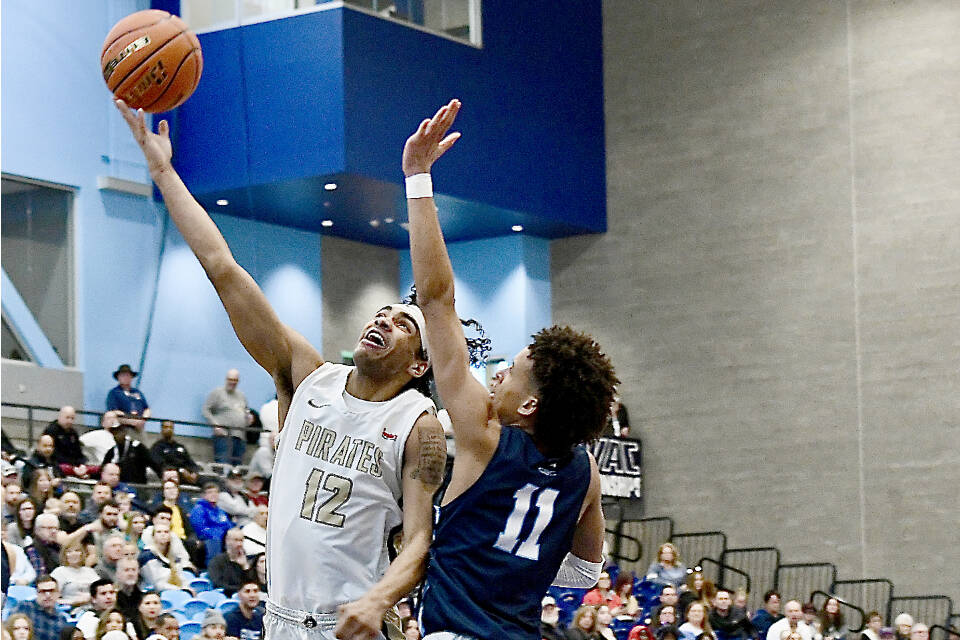 Peninsula College’s Roosevelt Williams Jr. goes up for a layup around Columbia Basin’s Ta’Veus Randle on Saturday in the NWAC tournament held in Pasco. Peninsula lost 77-73. (Jay Cline/Peninsula College)