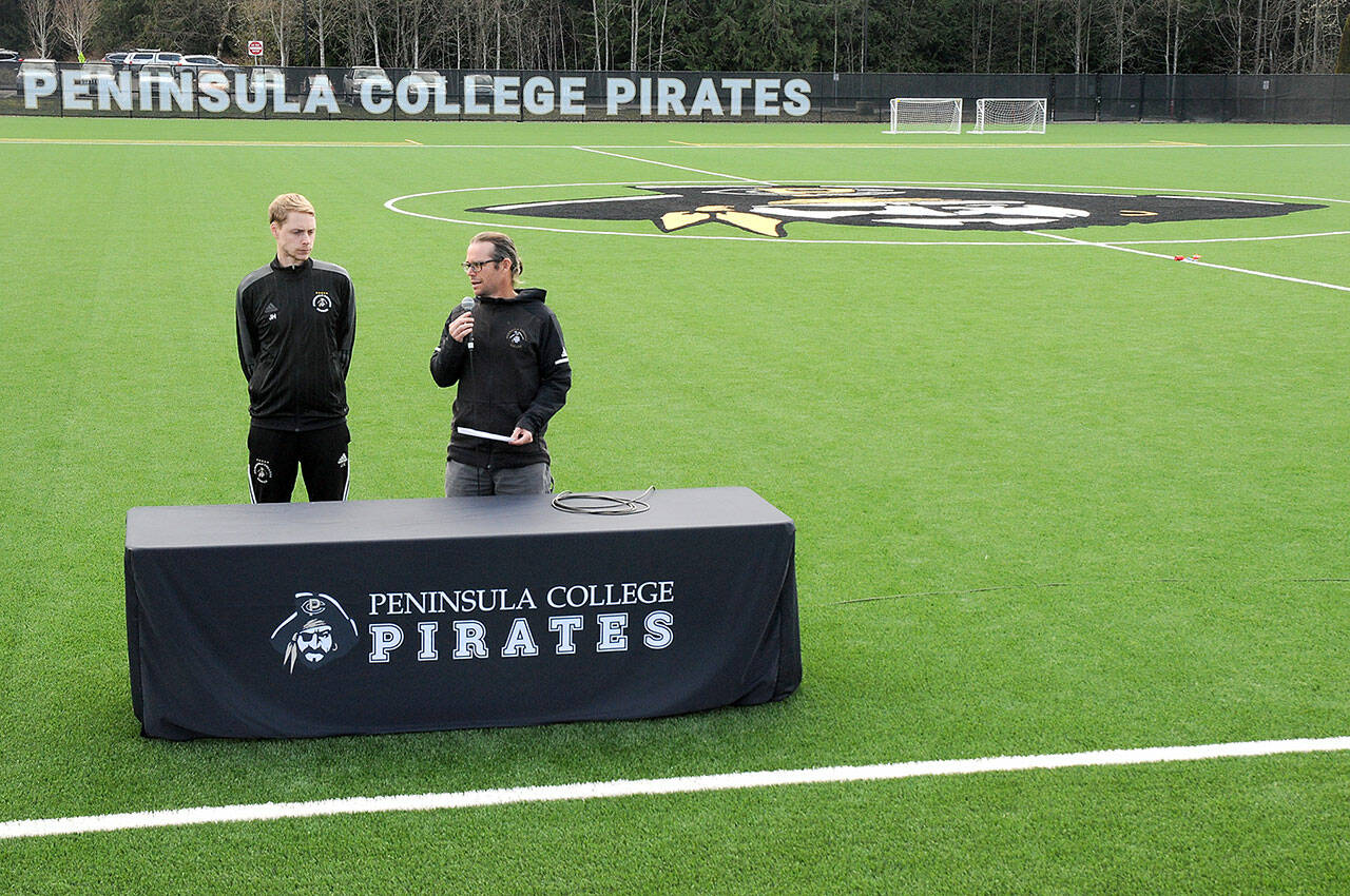 Peninsula College soccer coaches Jake Hughes, left, and Kanyon Anderson speak during the official opening of a new pitch surface at the Wally Sigmar Athletic Complex on Wednesday on the school’s Port Angeles campus. (Keith Thorpe/Peninsula Daily News)