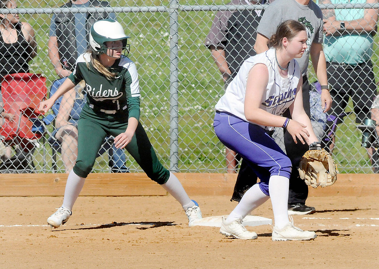 KEITH THORPE/PENINSULA DAILY NEWS Port Angeles’ Natalie Robinson, left, watches the pitch as Sequim first baseman Sammie Bacon keeps tabs during a May game in Port Angeles.