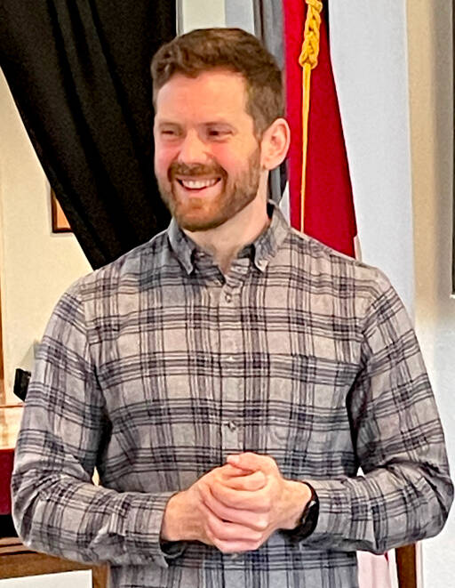 Tommy Farris, founder and owner of Olympic Hiking Co., speaks to the Port Angeles Business Association on Tuesday. The Freshwater Bay native’s business serves 3,000 hikers a year on guided tours, overnight backpacking trips and shuttles to trailheads in Olympic National Park. (Paula Hunt/Peninsula Daily News)