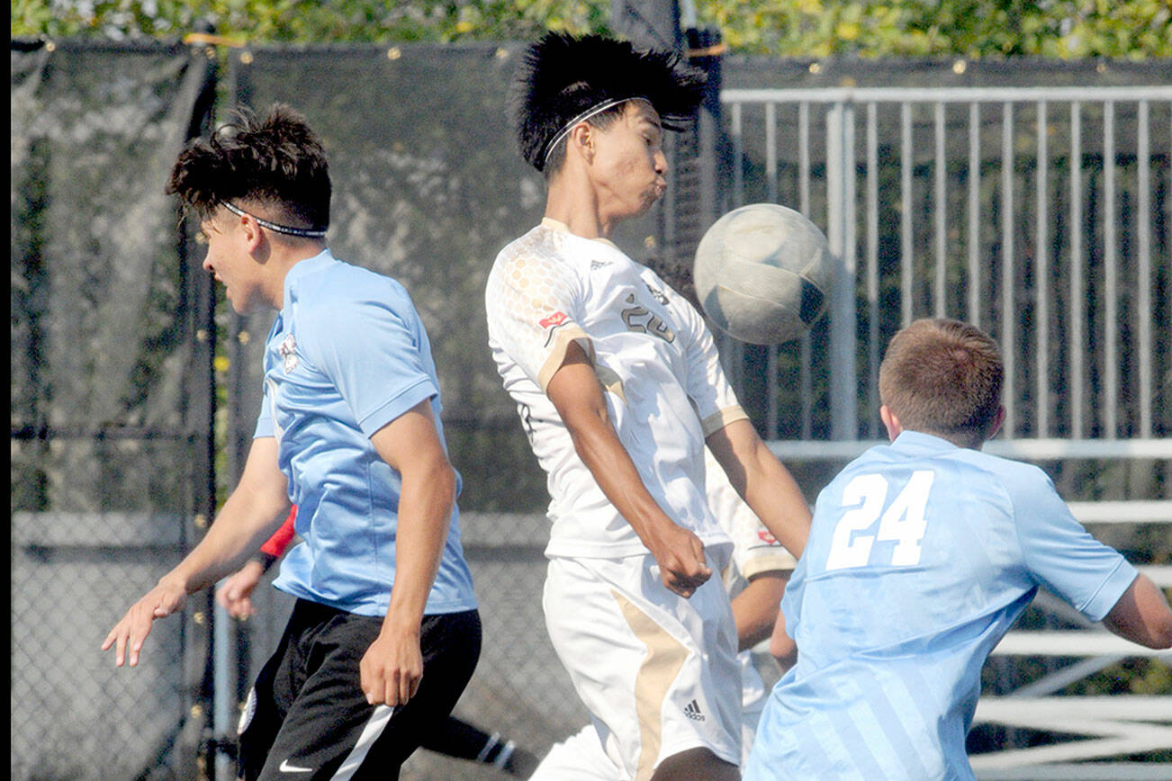 KEITH THORPE/PENINSULA DAILY NEWS
Peninsula's Matthew Enriquez, center, tries to settle the ball while surrounded by Pierce's Roel Degollado, left, and Payton Lambdin, right, and teammate Don Vaios Dovas, rear, during Saturday's match in Port Angeles.