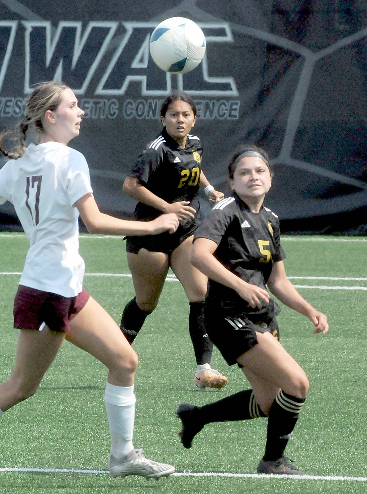 Peninsula’s Tara Bohenko, right, battles with North Idaho’s Marina Smith, left, for a loose ball as Bohenko’s teammate, Rylie Echavaria, looks on during Saturday’s match in Port Angeles. (Keith Thorpe/Peninsula Daily News)