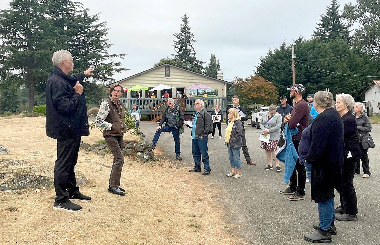 The Port Townsend City Council on Monday visited Mountain View Commons and the city golf course to get a first-hand look at the properties which are under consideration for alternative uses. Tim Caldwell, left, a member of the Port Townsend Golf Course stakeholder committee, describes the clubhouse and course layout. (Paula Hunt/Peninsula Daily News)