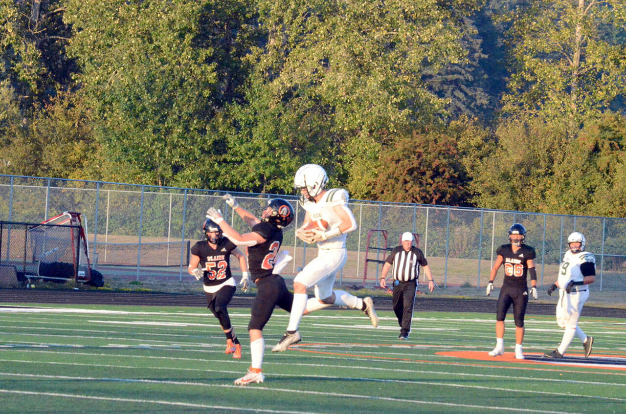 Port Angeles’ Blake Sohlberg hauls in this 45-yard catch-and-run touchdown pass to give the Roughriders a 9-0 lead early in their 44-21 win over Blaine Friday night. Sohlberg also had three interceptions. (Jack Kintner photo)