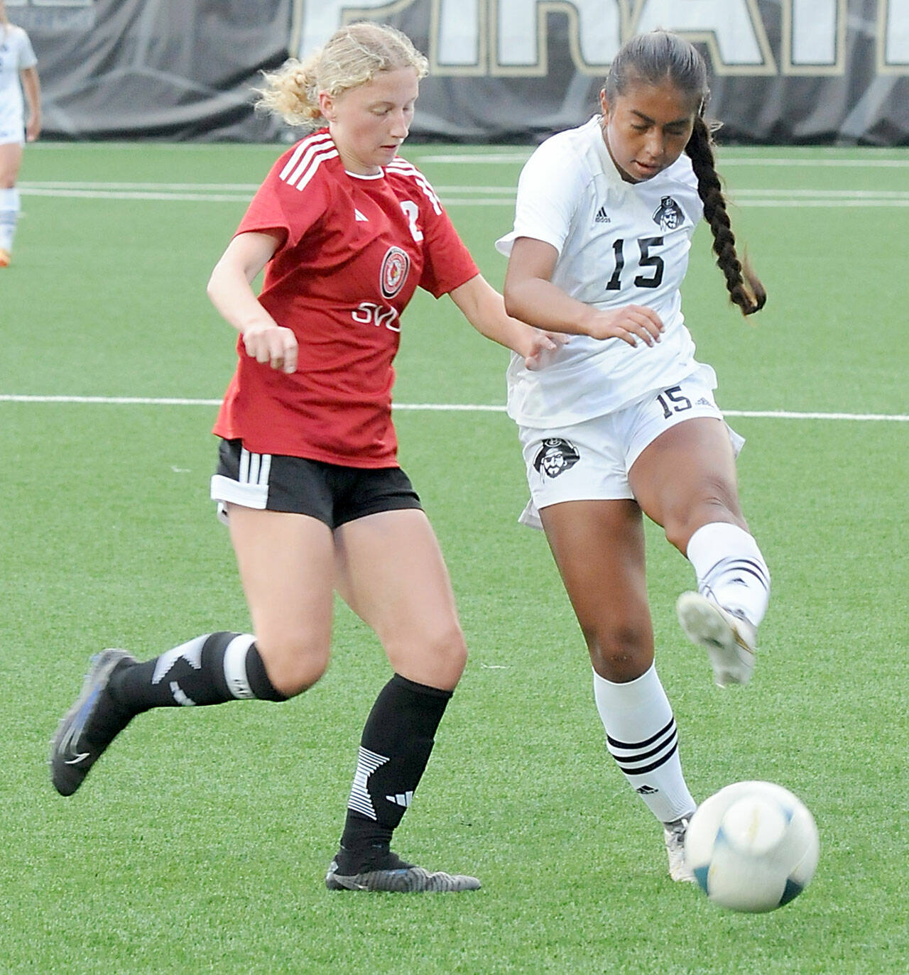 KEITH THORPE/PENINSULA DAILY NEWS Peninsula’s Alexia Rodriguez-Burdeaux, right, maneauvers past Skagit Valley’s Carly Bartlow on Wednesday in Port Angeles.
