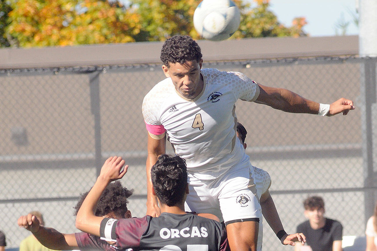 KEITH THORPE/PENINSULA DAILY NEWS
Peninsula's Fin Moutune, top, takes the header above Whatcom's Eduardo Rocha, front, and Josiah Dupree on Saturday in Port Angeles.