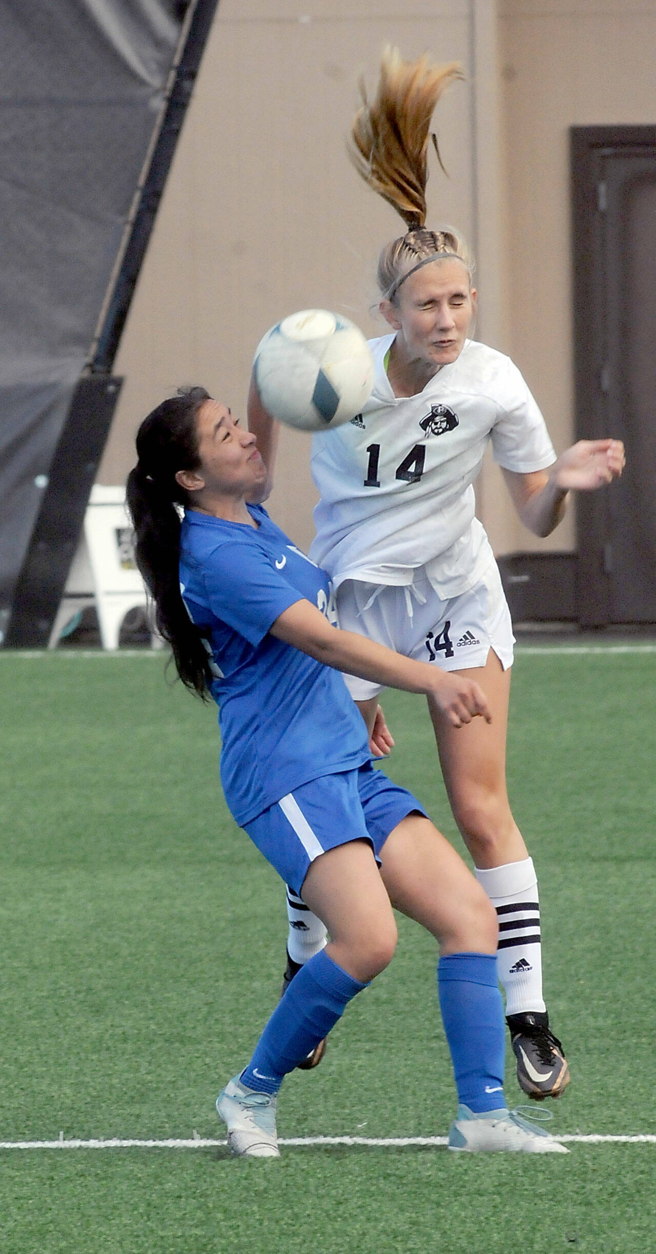 Peninsula’s Hannah Wagner deflects a header intended for Edmond’s Jennifer Wall Delamora during Wednesday’s match at Wally Sigmar Field. (Keith Thorpe/Peninsula Daily News)
