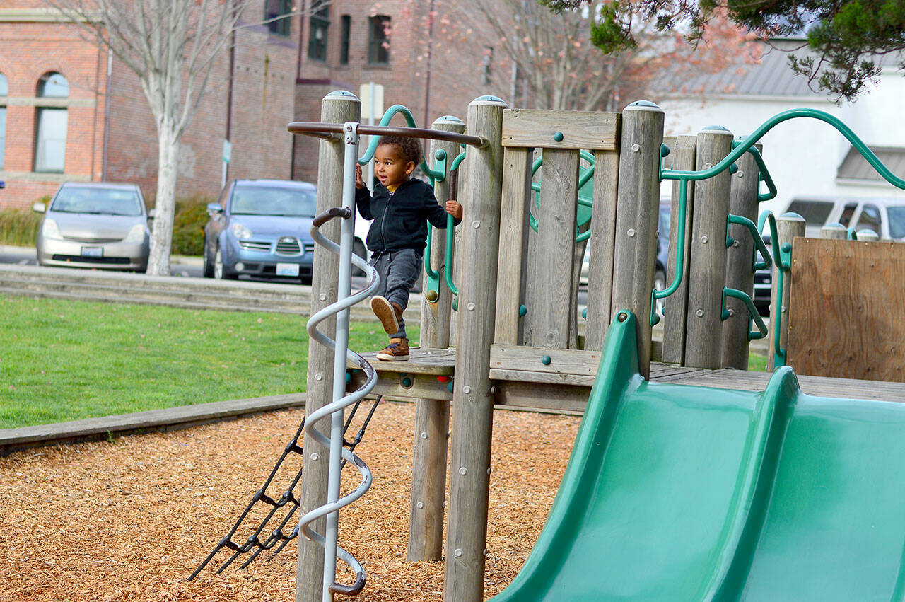 Liwane Senghor, 2 1/2, enjoys downtown Port Townsend’s playground despite the chilly wind. High temperatures are forecast to be in the upper 40s this week with rain showers likely. (Diane Urbani de la Paz/for Peninsula Daily News)