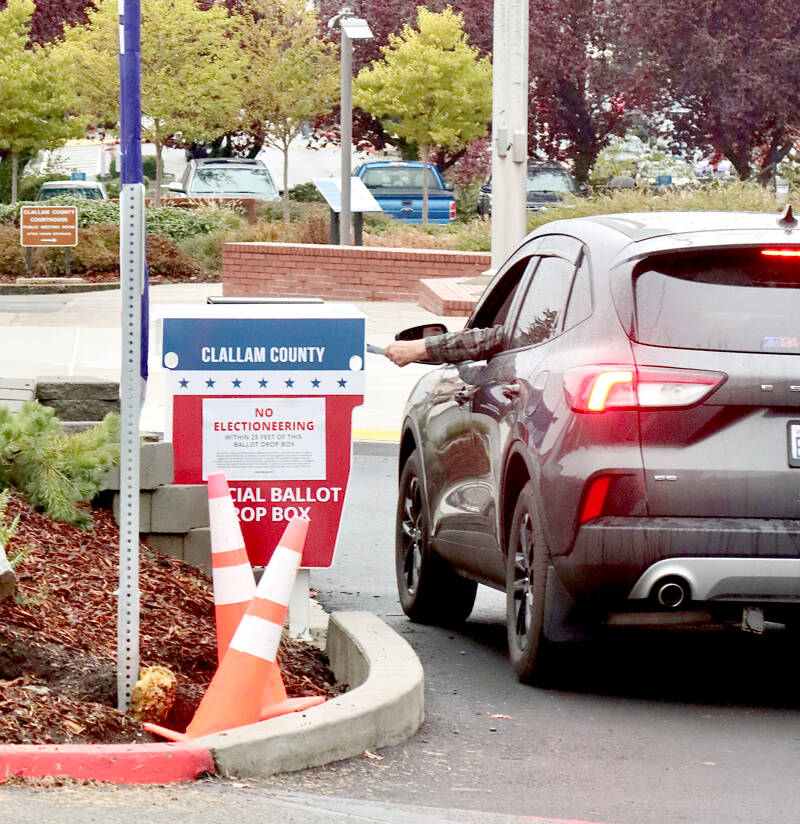 A voter drops off their ballot Monday morning at the Clallam County courthouse. Ballots must be postmarked or placed in an official dropbox by 8 p.m. tonight in order to be counted in the general election. (Dave Logan/for Peninsula Daily News)