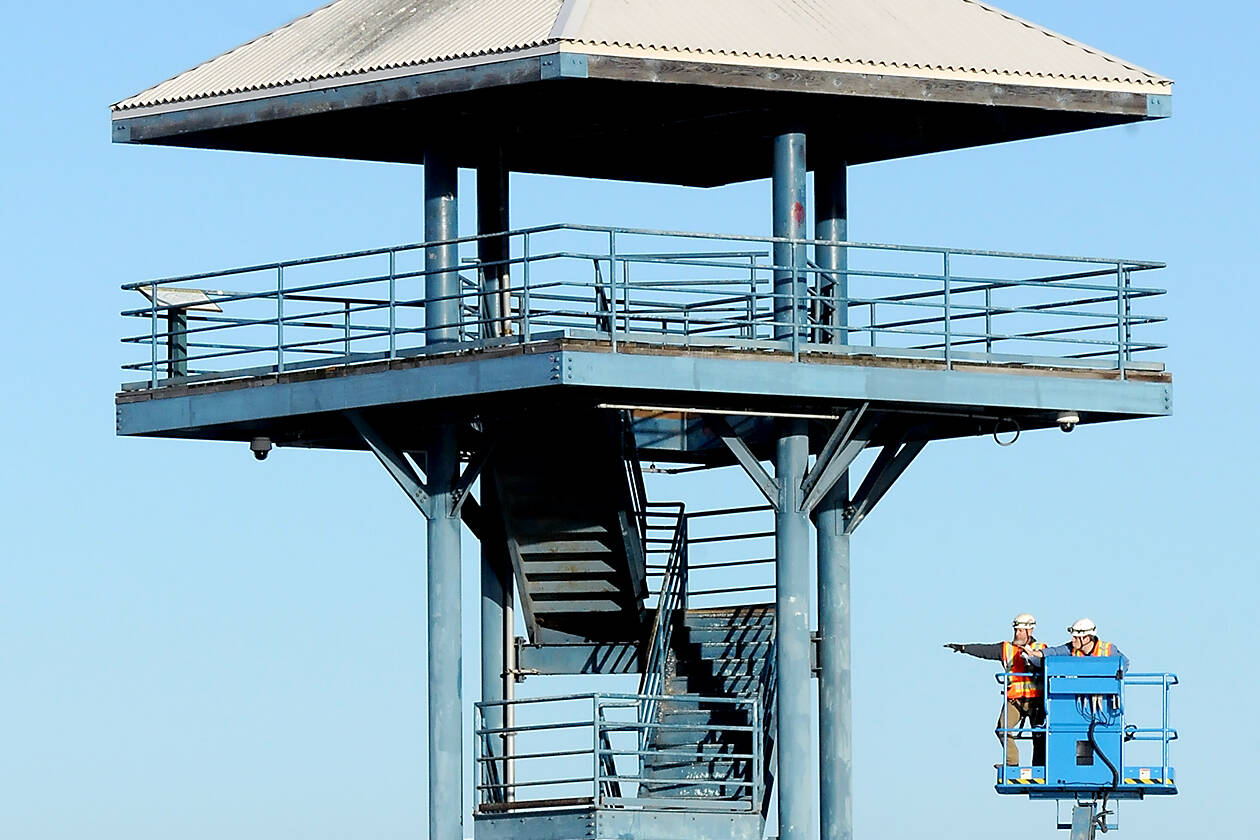 Craig Mallow, left, and Quinten Calquhoun of Olympia-based Sargent Engineers, Inc., use a lift to inspect the outside structure of the observation tower at the end of Port Angeles City Pier on Wednesday. (Keith Thorpe/Peninsula Daily News)