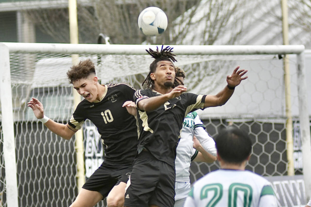 Peninsula College’s Nil Grau, left, and Abdurahim Leigh battle for a ball in front of the Highline net Sunday in Tukwila. (Jay Cline/Peninsula College)