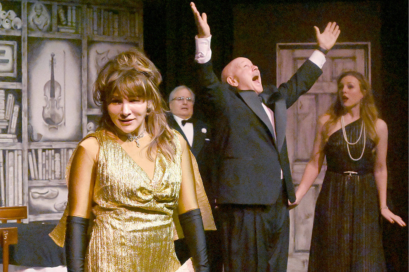 Michael Dashiell/Olympic Peninsula News Group

Acerbic magazine columnist Daria Chase (portrayed by Jamie Pauley) reveals that newly-married Simon Bright (Stephan Willms) has inherited a fortune in an early scene of “The Game’s Afoot or Holmes for the Holidays.” Looking on are host William Gillette (Joel Hoffman) and Bright’s new bridge, Aggie Wheeler (Merrin Packer).