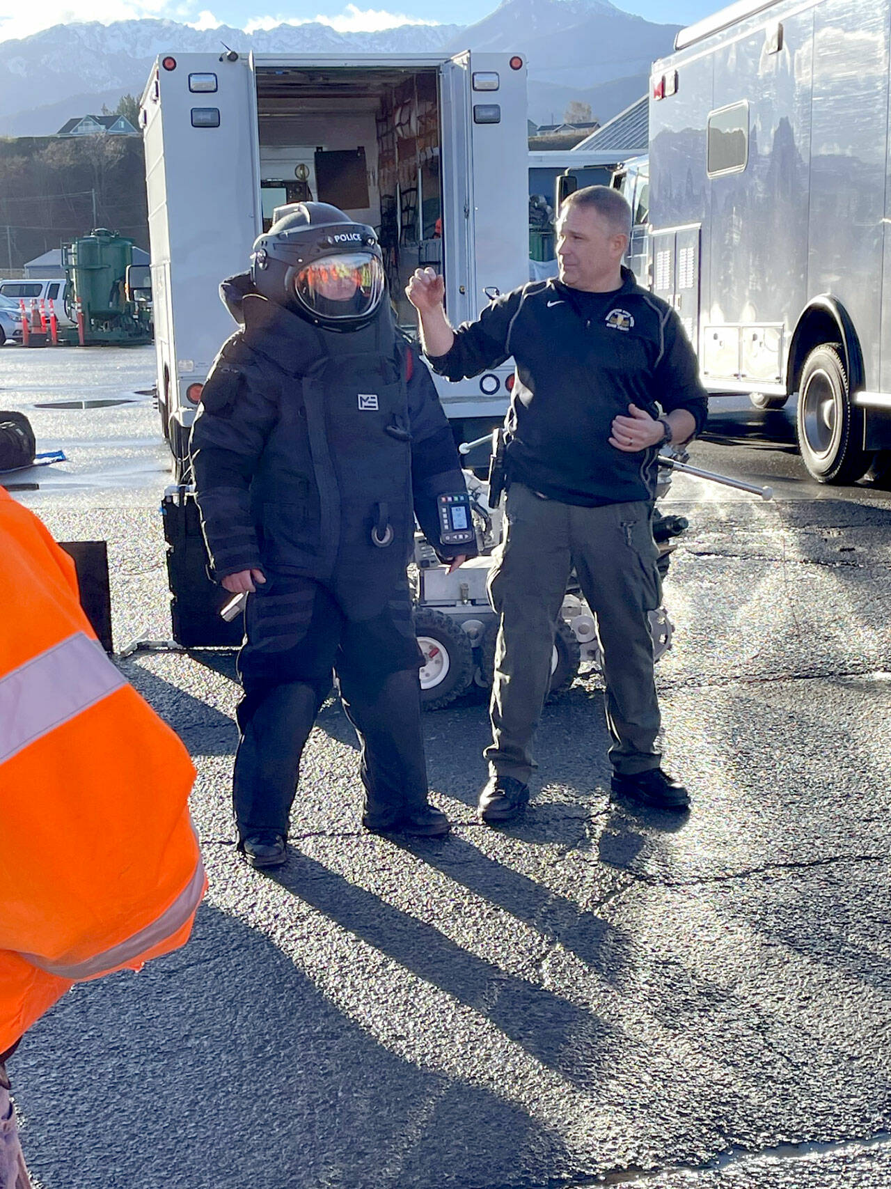Washington State Patrol Bomb Squad commander Cliff Pratt, right, describes and explains the function of a blast suit worn by bomb technician Dan Betts to security staff at the Port of Port Angeles. The squad visited the port Friday for a presentation on its response protocols, tools and equipment. (Paula Hunt/Peninsula Daily News)