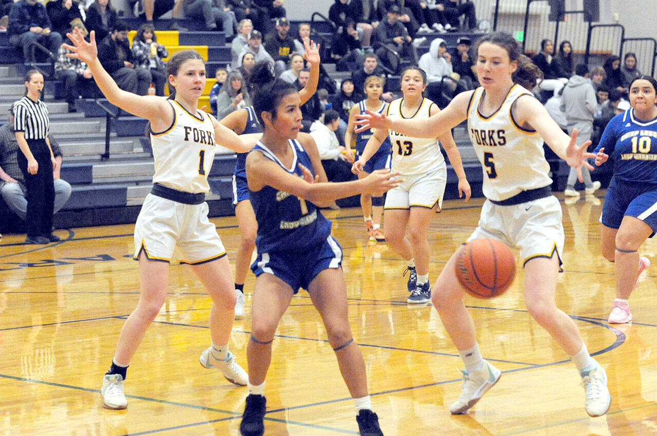 Lonnie Archibald/for Peninsula Daily News
Forks sisters Bailey Johnson, left, and Keira Johnson get defensive against Chief Leschi in Forks where the Spartans defeated the Warriors 78-26.