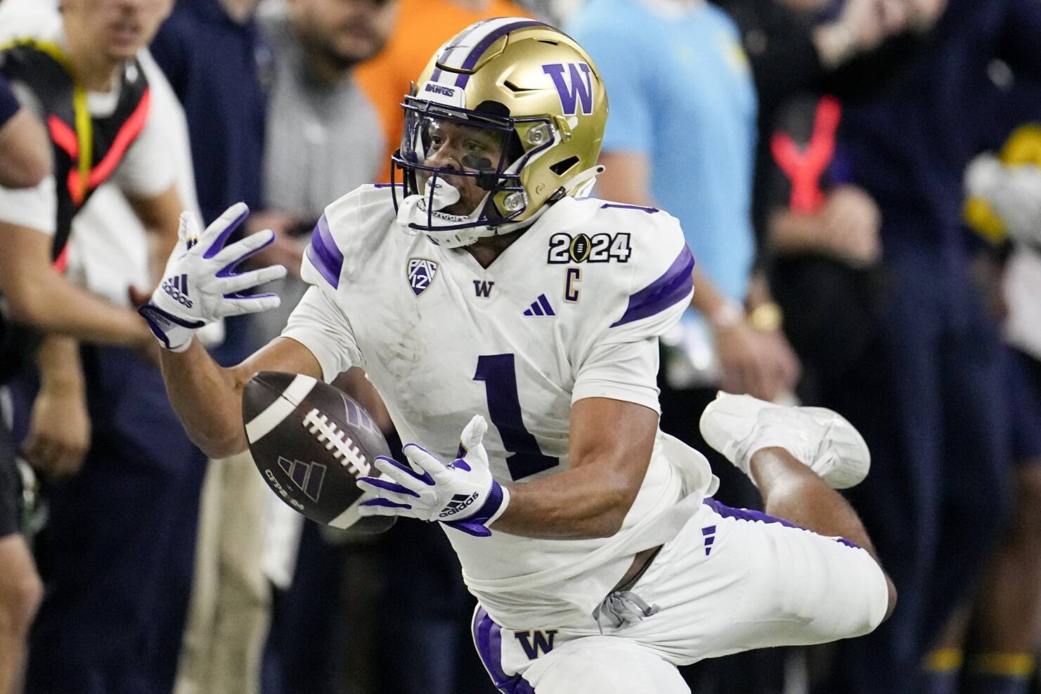 Washington wide receiver Rome Odunze can't get a hold of a pass against Michigan during the second half of the national championship NCAA College Football Playoff game Monday, Jan. 8, 2024, in Houston. (AP Photo/David J. Phillip)