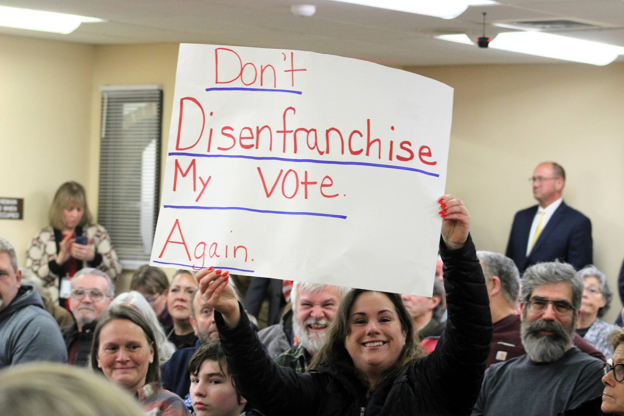 Several signs were brought into the packed Kitsap County courtroom on Tuesday. (Elisha Meyer/Kitsap News Group)