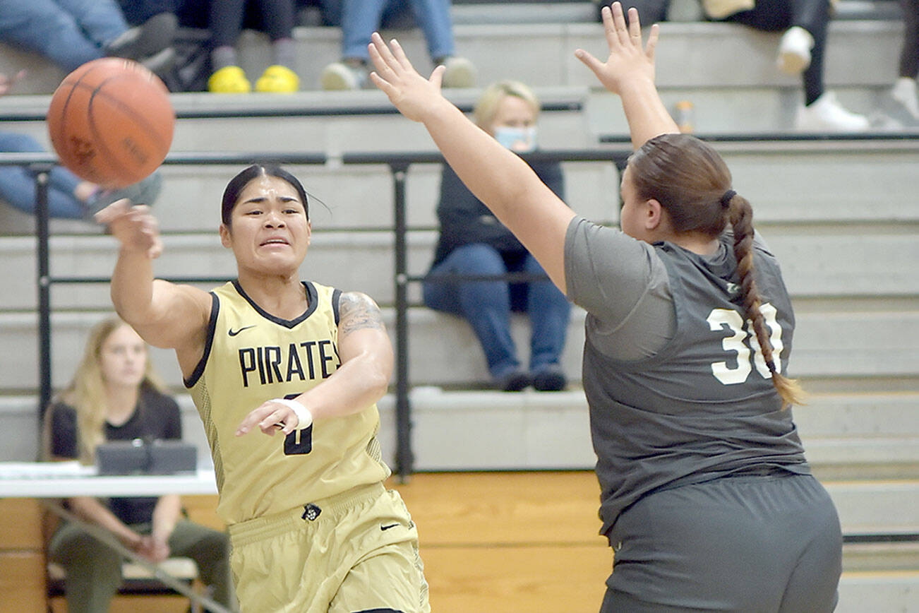 Peninsula's Ciera Agasiva, left, passes along the baseline as Shoreline's Leiah Naeata tries to block on Wednesday night in Port Angeles. (Keith Thorpe/Peninsula Daily News)