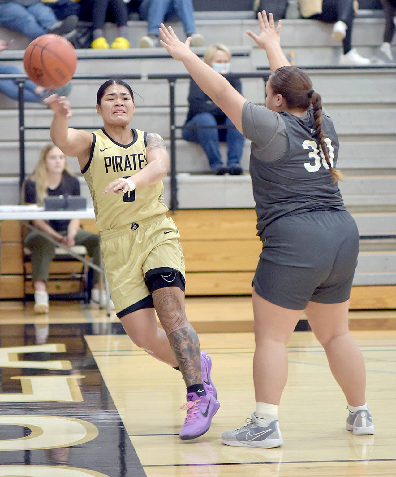Peninsula’s Ciera Agasiva, left, passes along the baseline as Shoreline’s Leiah Naeata tries to block on Wednesday night in Port Angeles. (Keith Thorpe/Peninsula Daily News)