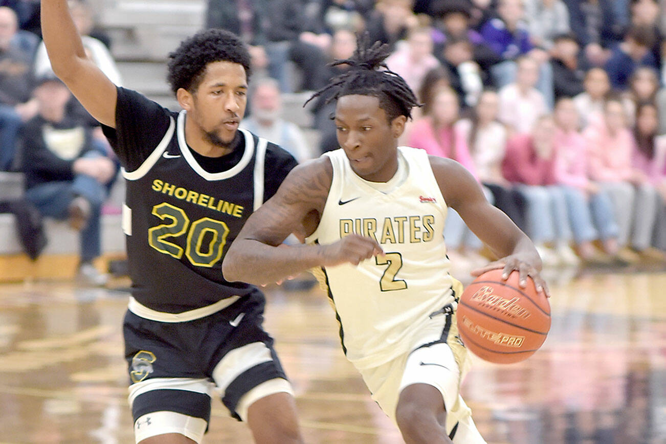 KEITH THORPE/PENINSULA DAILY NEWS 
Peninsula's Ese Onakpoma, right, races with Shoreline's Jamikal Davis on Wednesday in Port Angeles.