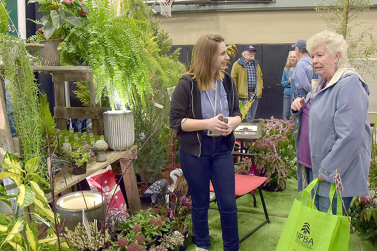Dianne McIntosh of Sequim, right, chats about gardening with Jayde Carean, an employee of New Dungeness Nursery, during Saturday’s Building, Remodeling & Energy Expo at Sequim Middle School. The two-day event, hosted by the North Peninsula Building Association and sponsored by Clallam County PUD No. 1., featured displays, workshops and vendor booths showcasing a variety of building products and services. (Keith Thorpe/Peninsula Daily News)