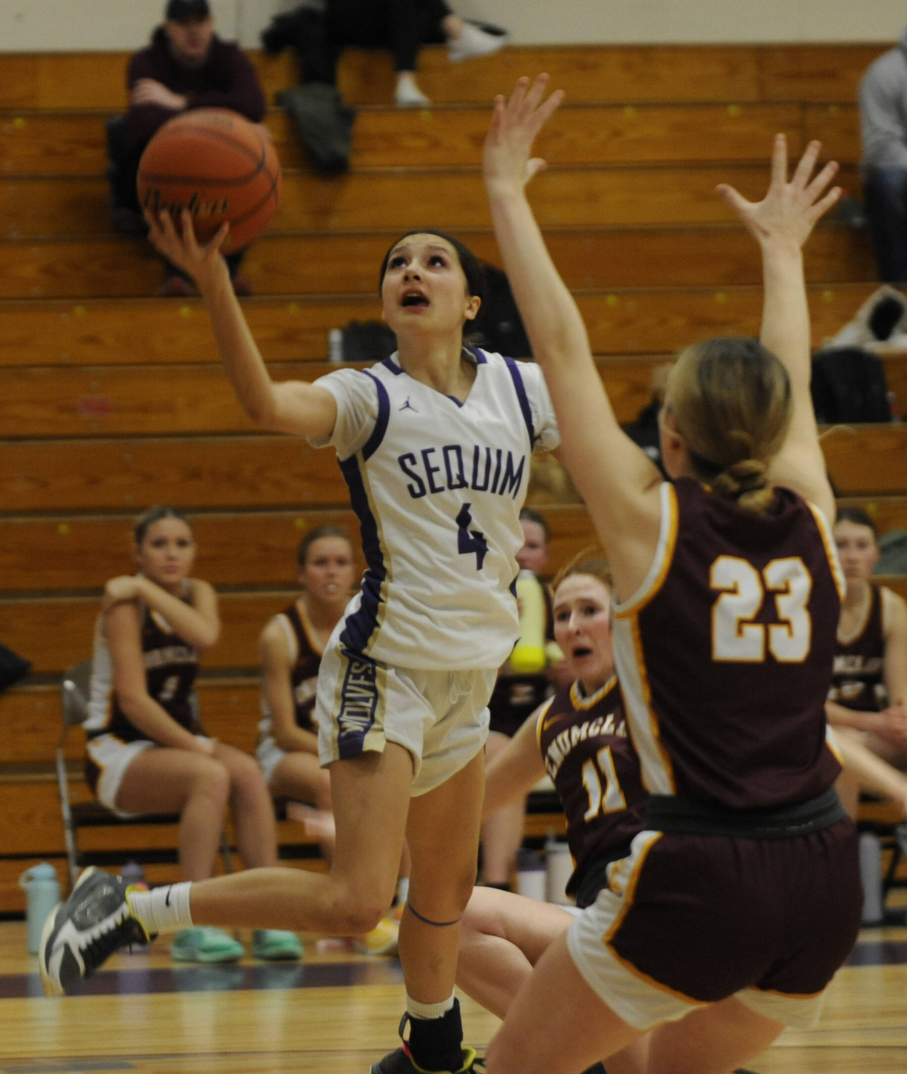 Sequim’s Gracie Chartraw avoids the defense of Enumclaw’s Sydney VanHoof, center, and Ava Smith during the Wolves’ Class 2A bi-district defeat at home Wednesday. (Michael Dashiell/Olympic Peninsula News Group)