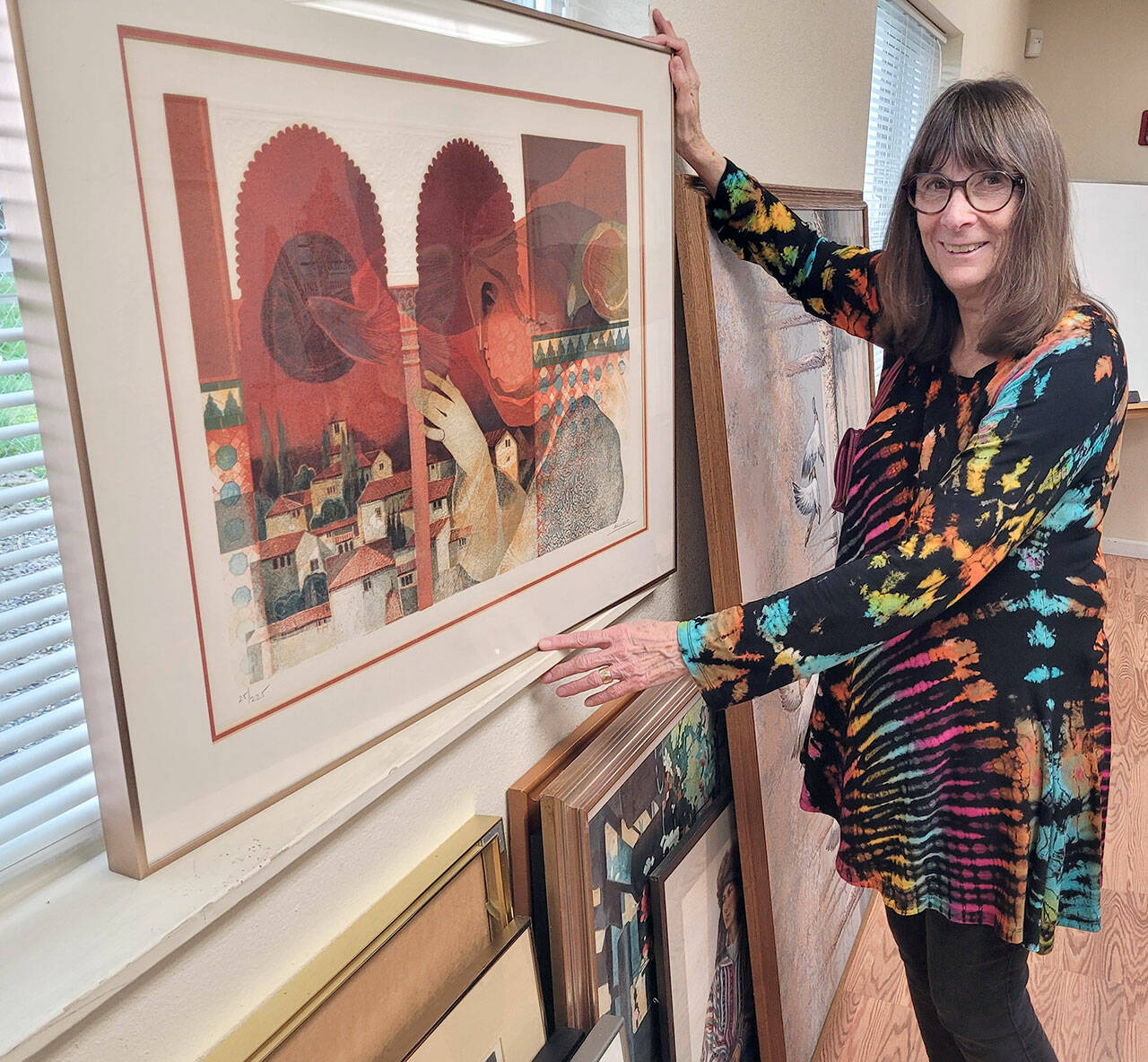 Shipley Center Program Director Reba Renner, program director at the Shipley Center, sorts through more than 80 works of art that will be sold at the center’s art soiree Thursday evening.