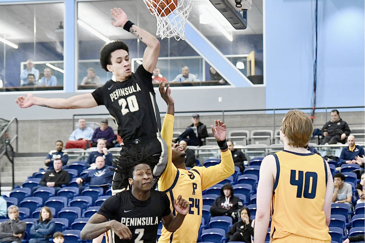 Peninsula College's DeShawn Rushmeyer (20) and Ese Onakpoma (2) battle for a rebound with Portland's Nydir Hodges (24) and Josh Lincoln (40) in the opening round of the NWAC tournament in Pasco on Wednesday. (Jay Cline/Peninsula College)