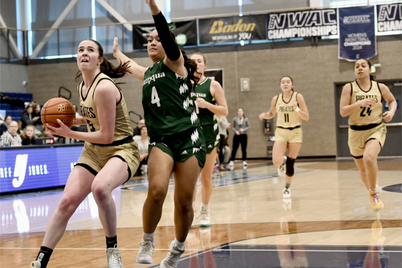 Peninsula College’s Alexa Mackey goes to the rim up against Umpqua’s Amaya Afatasi (4) on Saturday in Pasco. Trailing the play are Peninsula’s Jenilee Donovan (11) and Shania Moananu (24). Umpqua won 73-55. (Jay Cline/Peninsula College)