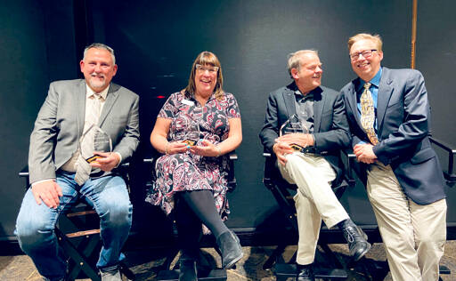 From left to right, Sean Coleman, Colleen Robinson, Brown Maloney and Todd Ortloff display the awards they earned Friday during the annual gala of the Clallam County Economic Development Council at Field Arts & Events Hall in Port Angeles (Lorie Fazio/Clallam County EDC)