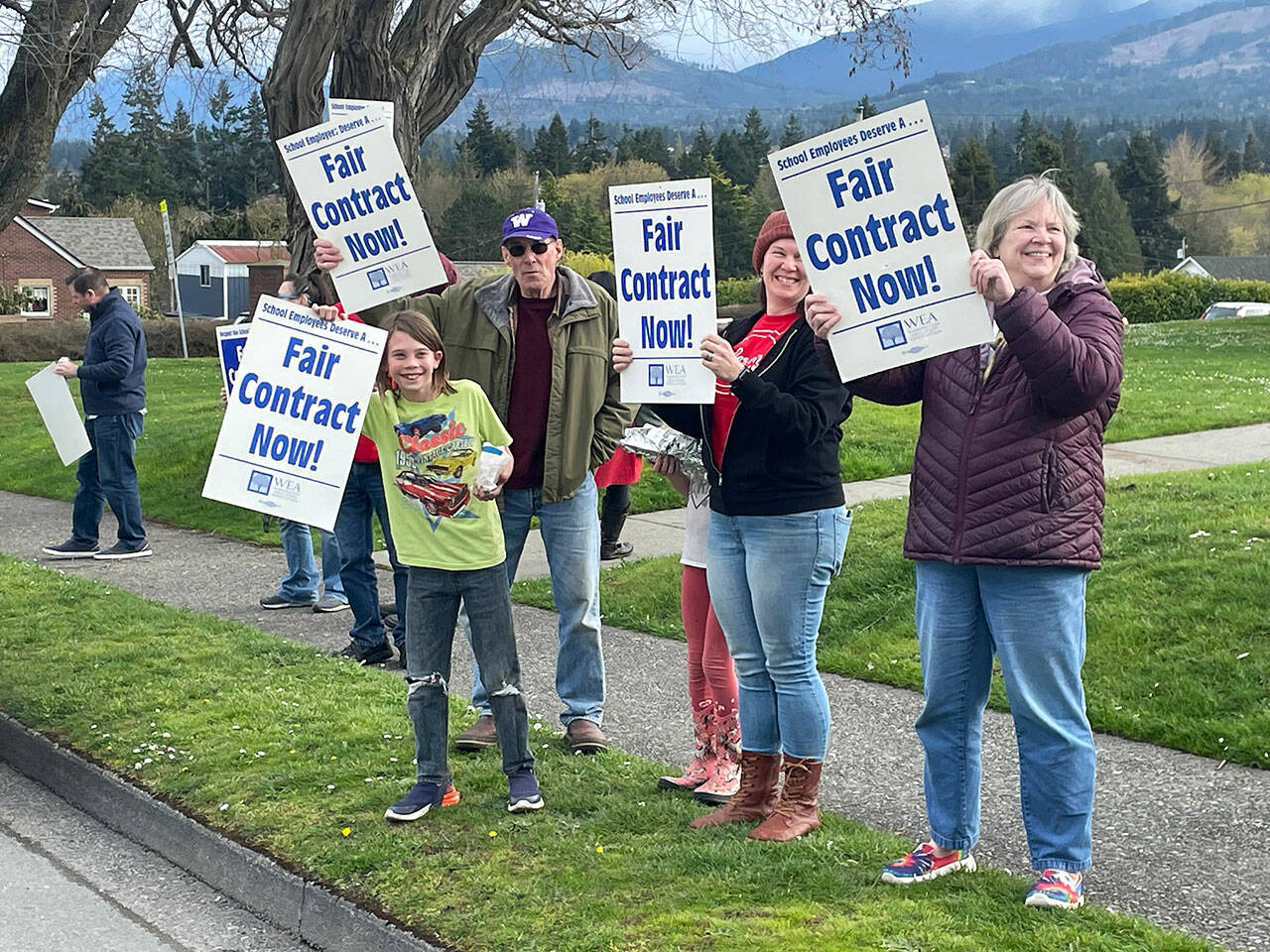 Supporters of paraeducators rally outside the Port Angeles School District administration headquarters at Lincoln Center on Thursday. The Port Angeles Paraeducators Association has voted to strike April 8 if an agreement with the PASD for a 3.7 percent wage increase can’t be reached. (Paula Hunt/Peninsula Daily News)