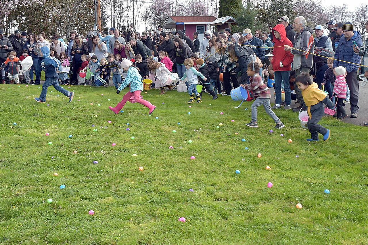 Children take off from the starting ropes in search of prize-filled eggs at the 46th annual KONP Easter Egg Hunt on Saturday at the Clallam County Fairgrounds in Port Angeles. Hundreds of youngsters took part in the event. (Keith Thorpe/Peninsula Daily News)