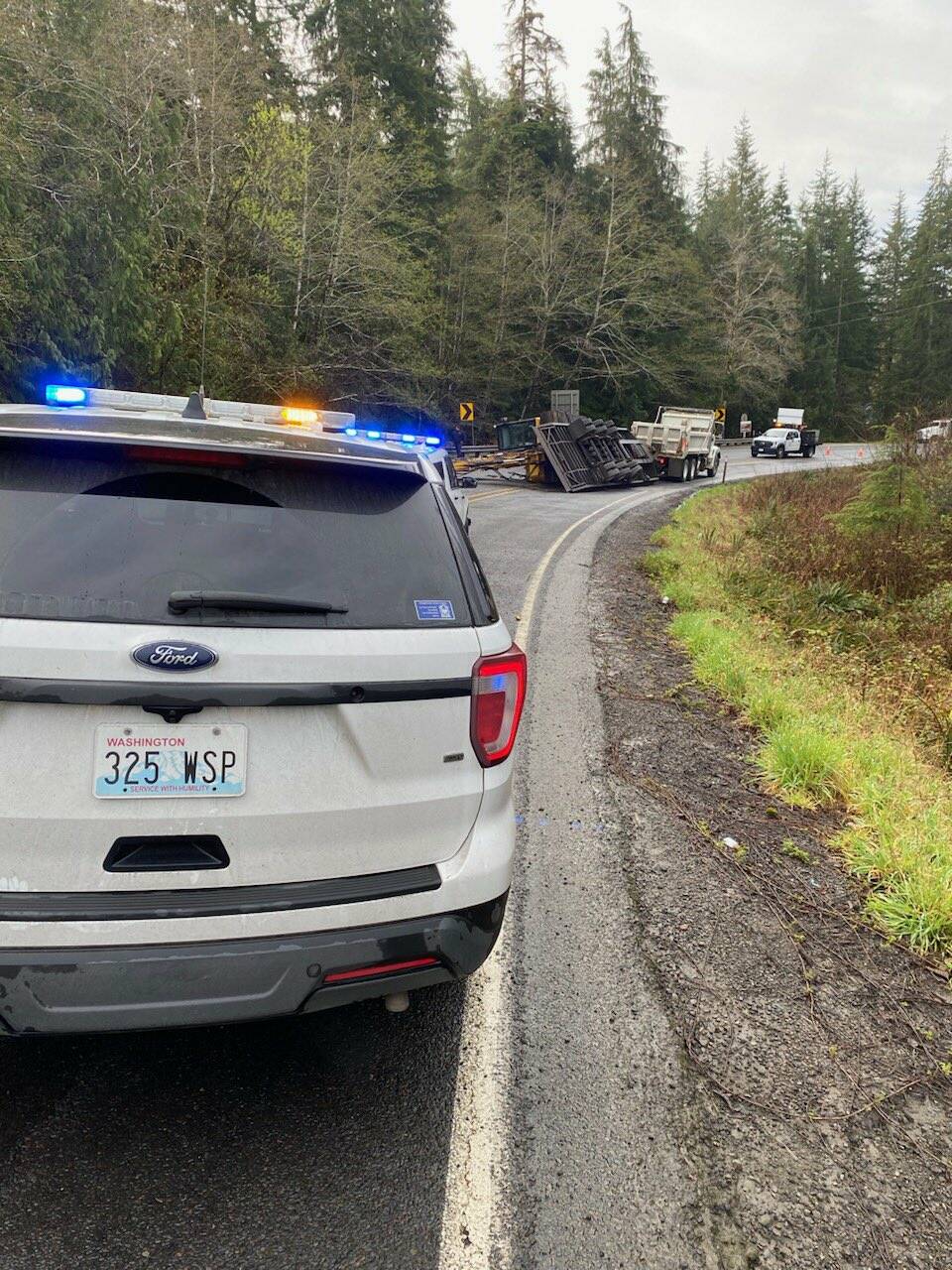 U.S. Highway 101 is fully blocked at MP 177 for a roll over collision involving a trailer hauling an excavator. (Katherine Weatherwax/Washington State Patrol via X)