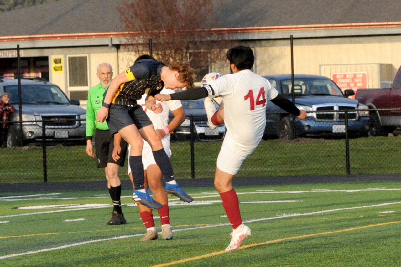 Forks’ Brody Owen, left, goes head-to-toe with Hoquiam’s Daniel Rosales on Wednesday evening at Spartan Stadium. (Lonnie Archibald/for Peninsula Daily News)