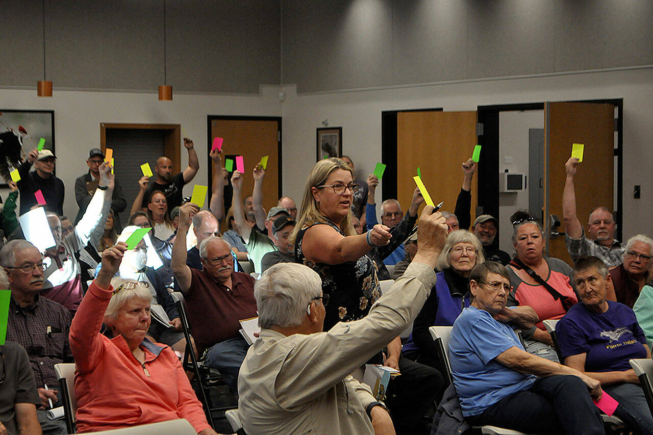 Sequim Gazette photo by Matthew Nash/ Julie Vig, secretary/treasurer for the Sequim Prairie Tri-Irrigation Association, tallies votes during a special meeting of shareholders. Board members continued the association's February annual meeting on May 14 after contention over proper notification about meetings and their legitimacy. Shareholders voted to reinstate board members from 2023.