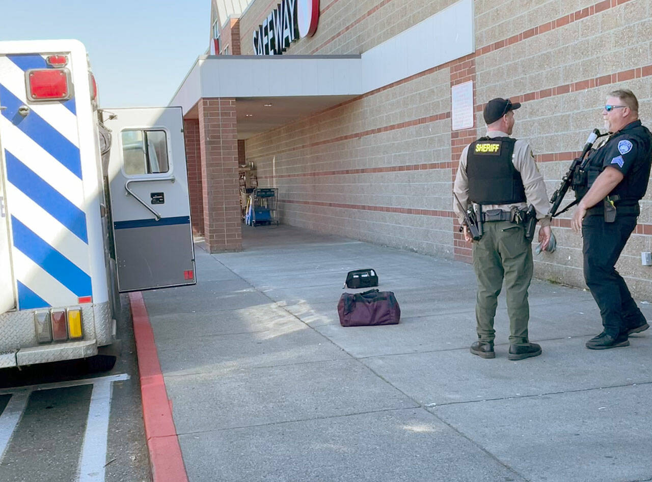 Law enforcement personnel respond to a call Monday afternoon at the Port Angeles Safeway on Lincoln Street after a man threatened homicide and suicide. (Paul Gottlieb/for Peninsula Daily News)