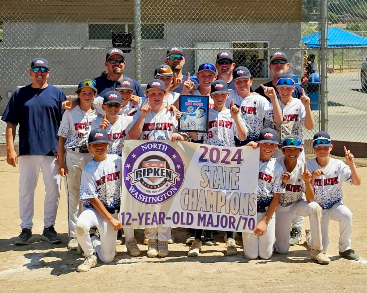 The North Olympic Cap Ripken team won the state 12 and under championship this weekend in Wenatchee. From left, front row, are Julian Dominguez, Noah Kiser, Coleman Keate and Kade Johnstad. From left, second row, are Jay Lieberman, Kyler Williams, Brycen Allen, Cooper Merritt, Gavin Doyle, Jacob Kinzey, Drake Spence, Liam Shea and Carson Greenstreet. From left, back row, are coaches Grian Greenstreet, Evan Kiser, Tyril Spence, Riley Shea and manager Rob Merritt. (Courtesy of Rob Merritt)