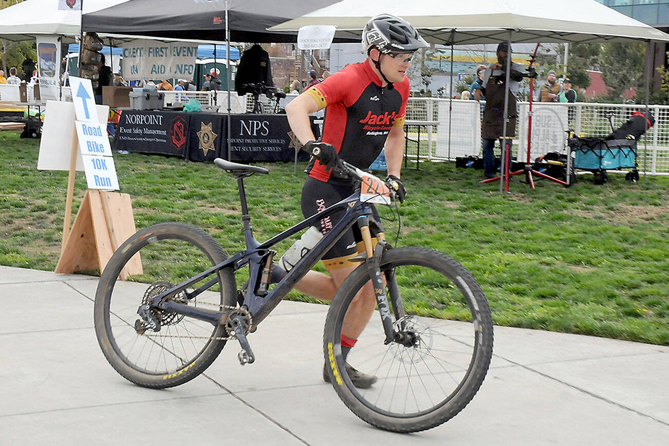 Calvin Colander of Bellingham-based Team Improbability Drive heads for the handoff after finishing the mountain bike leg of the 2023 Big Hurt in Port Angeles. (Keith Thorpe/Peninsula Daily News)