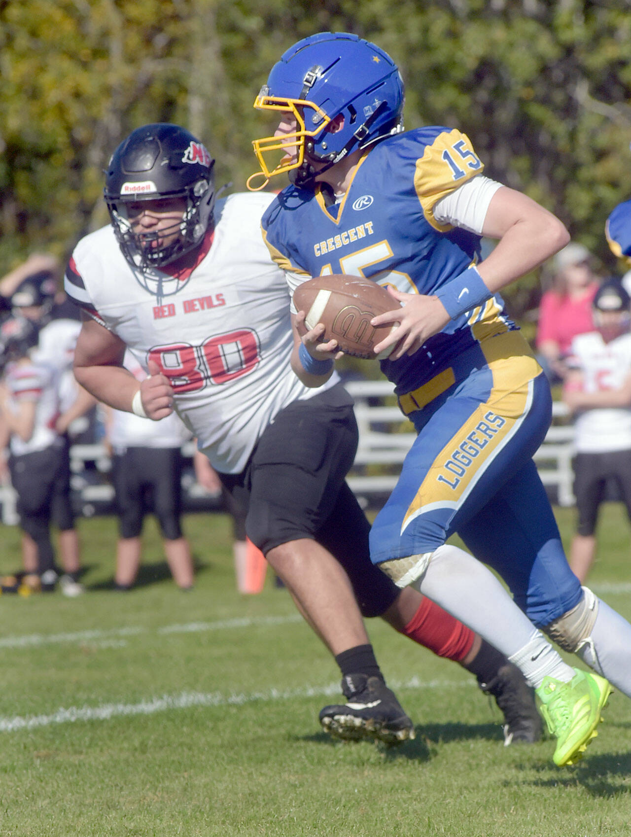Crescent’s Henry Bourm, front, carries the ball as Neah Bay’s Carlos Carrick-Aguirre gives chase on Saturday afternoon in Joyce. (Keith Thorpe/Peninsula Daily News)
